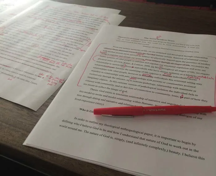 red pen editing a paper.