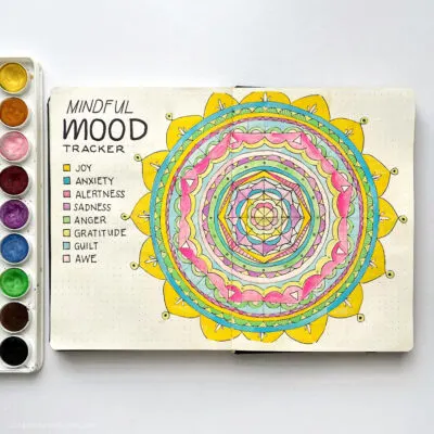 A mandala in a bullet journal being used to track moods.