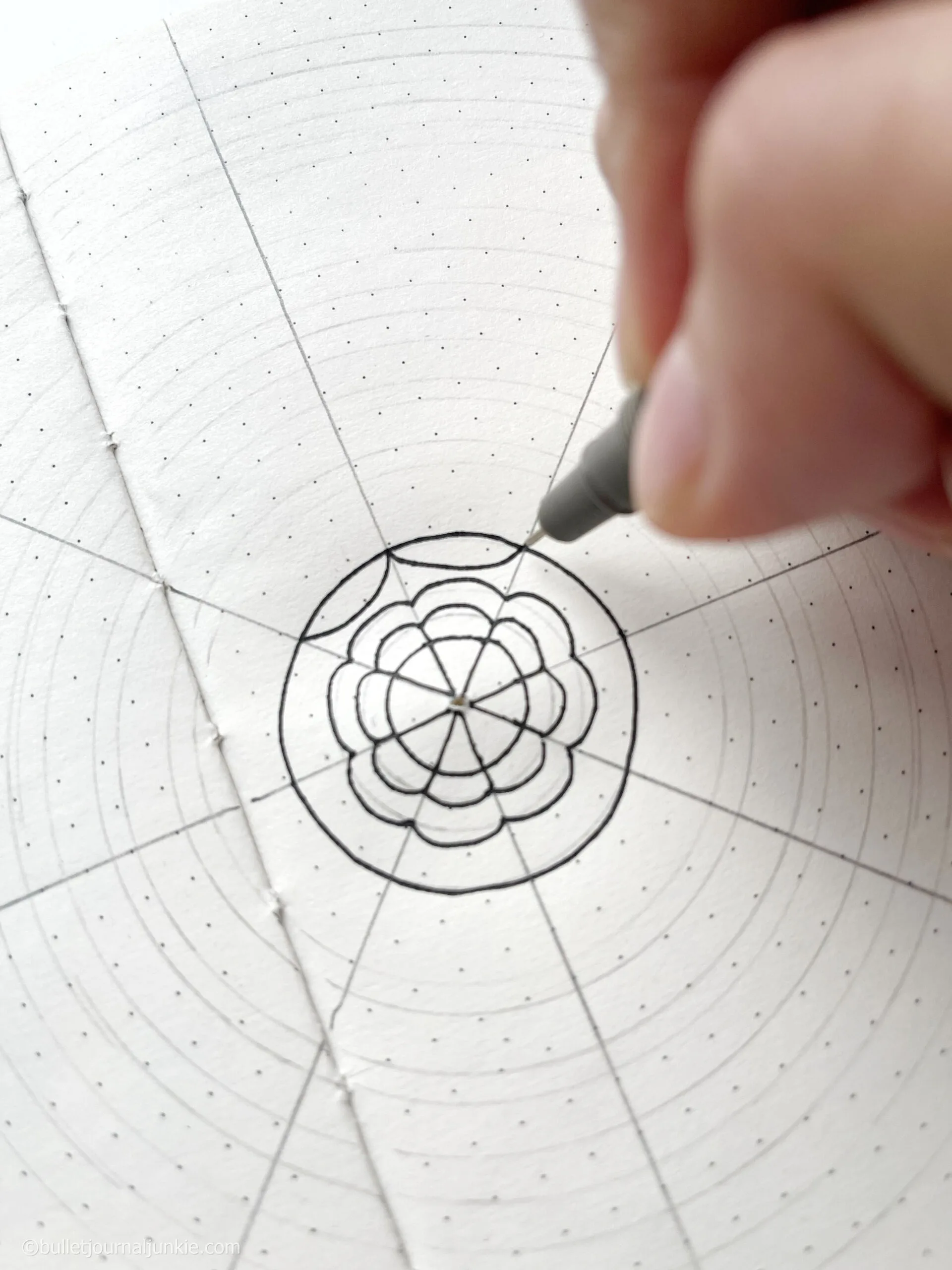 A pen drawing a mandala as part of a mindfulness practice.