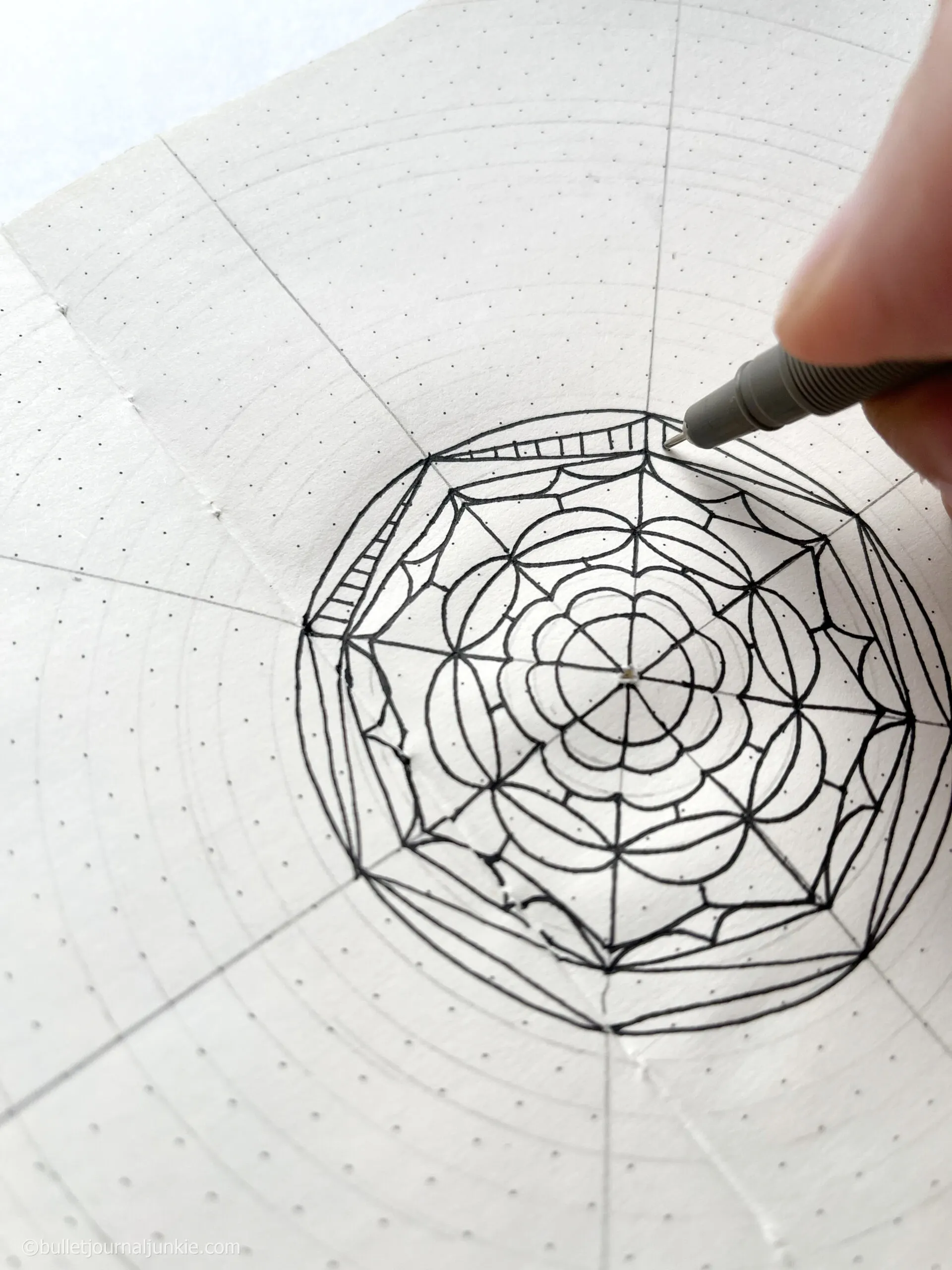 A pen drawing a mandala as part of a mindfulness practice.