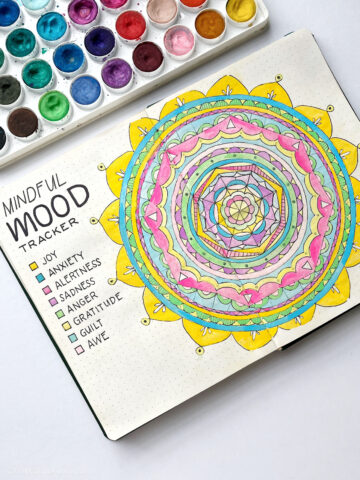 A mandala in a bullet journal being used to track moods.
