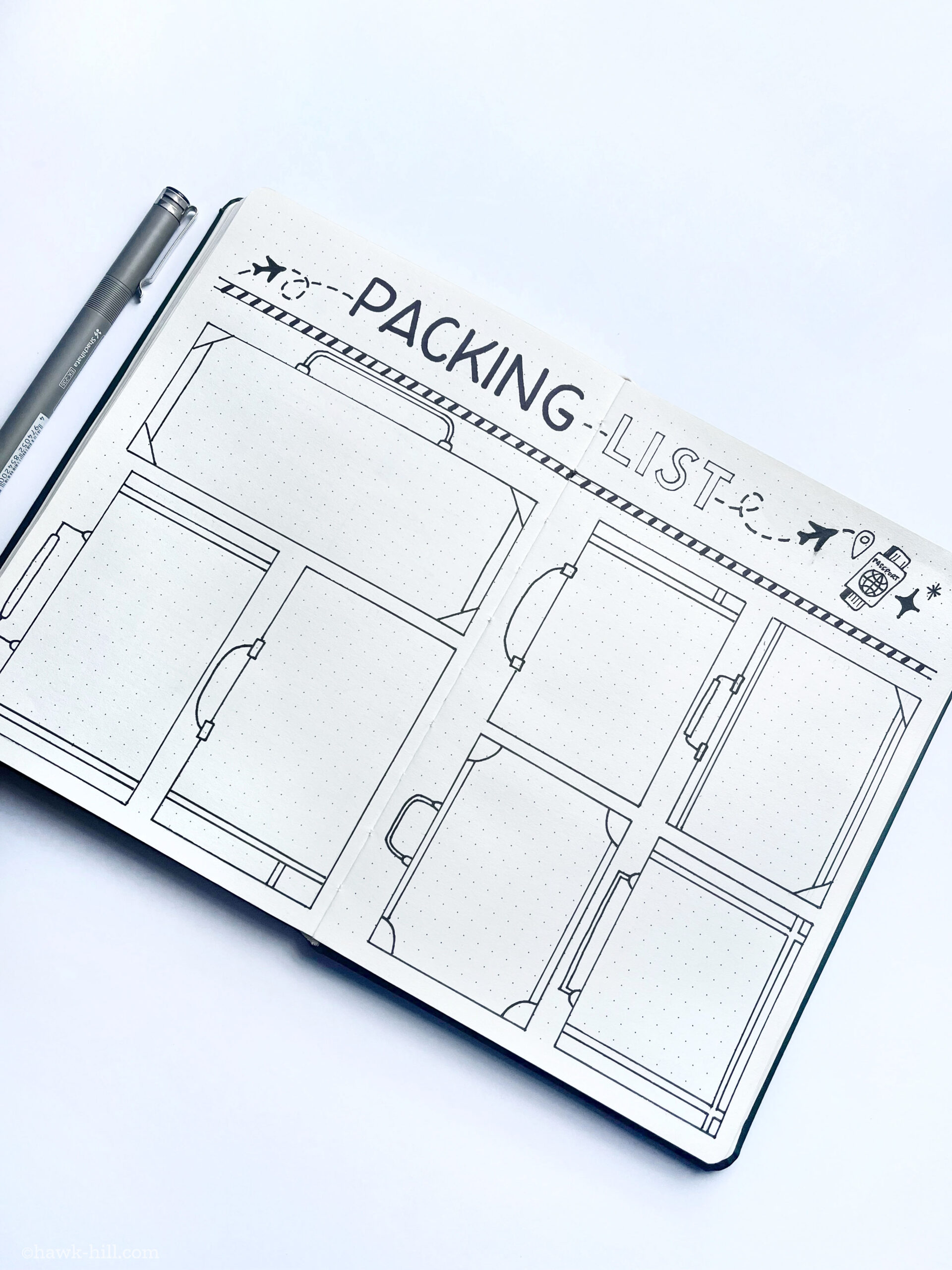 packing list bullet journal layout being drawn in ink on a page.
